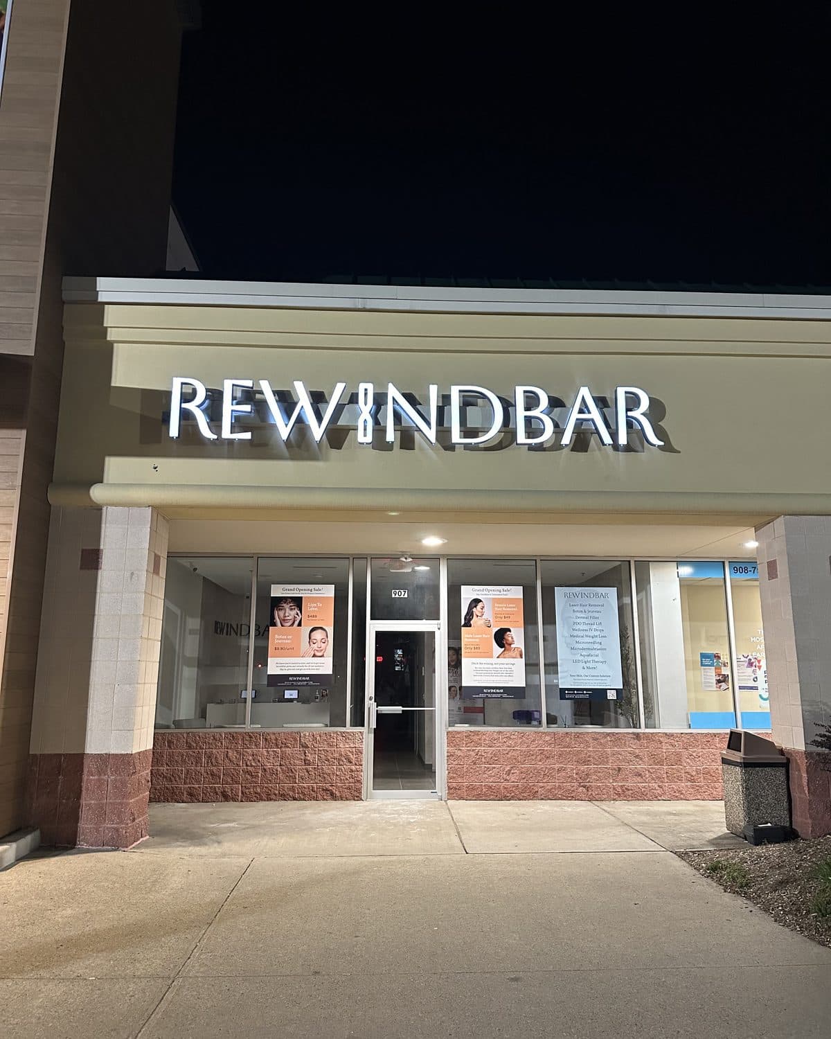 The Rewind Bar storefront in South Plainfield at night, with the sign lit