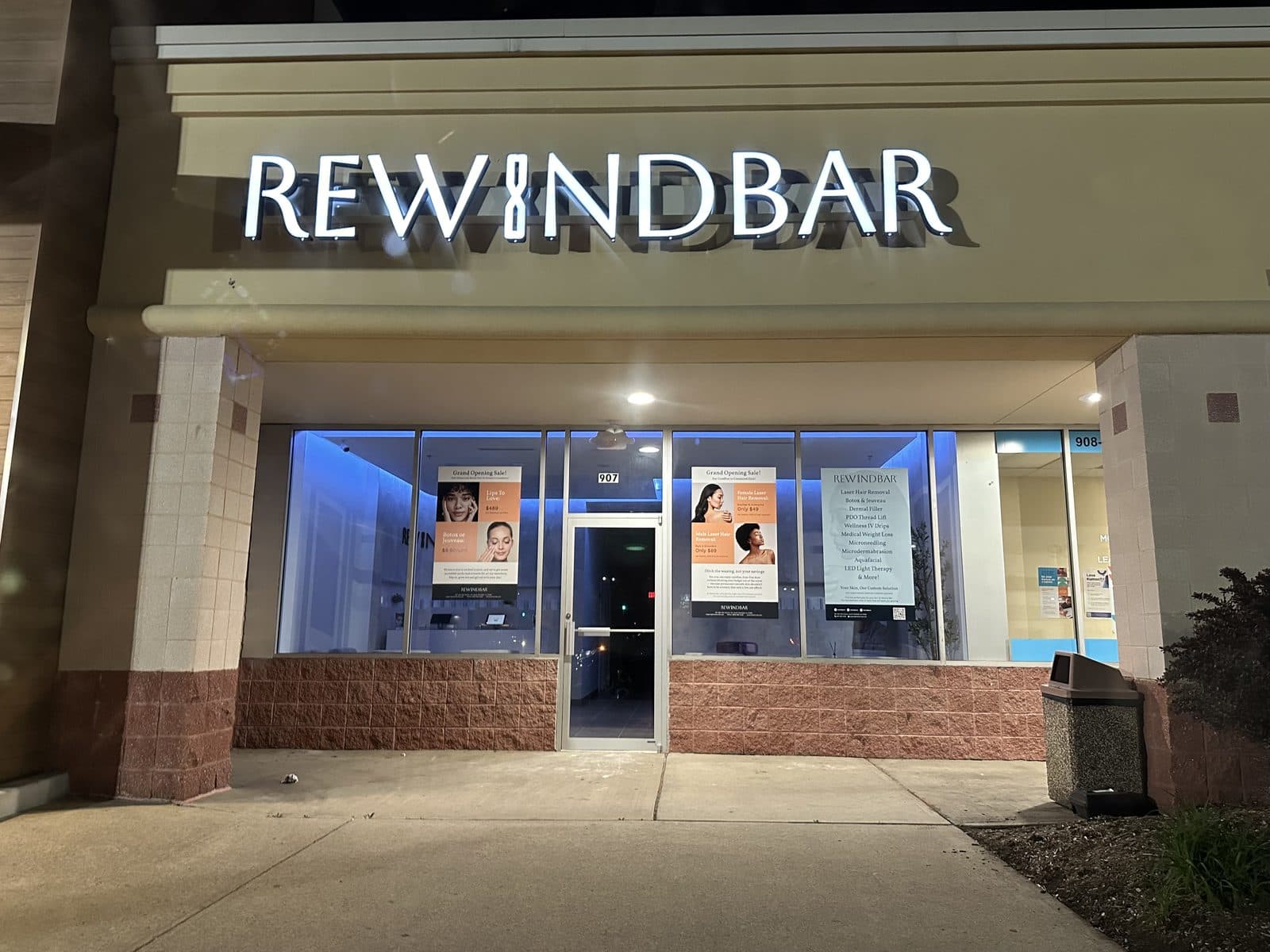 The Rewind Bar storefront lit at night