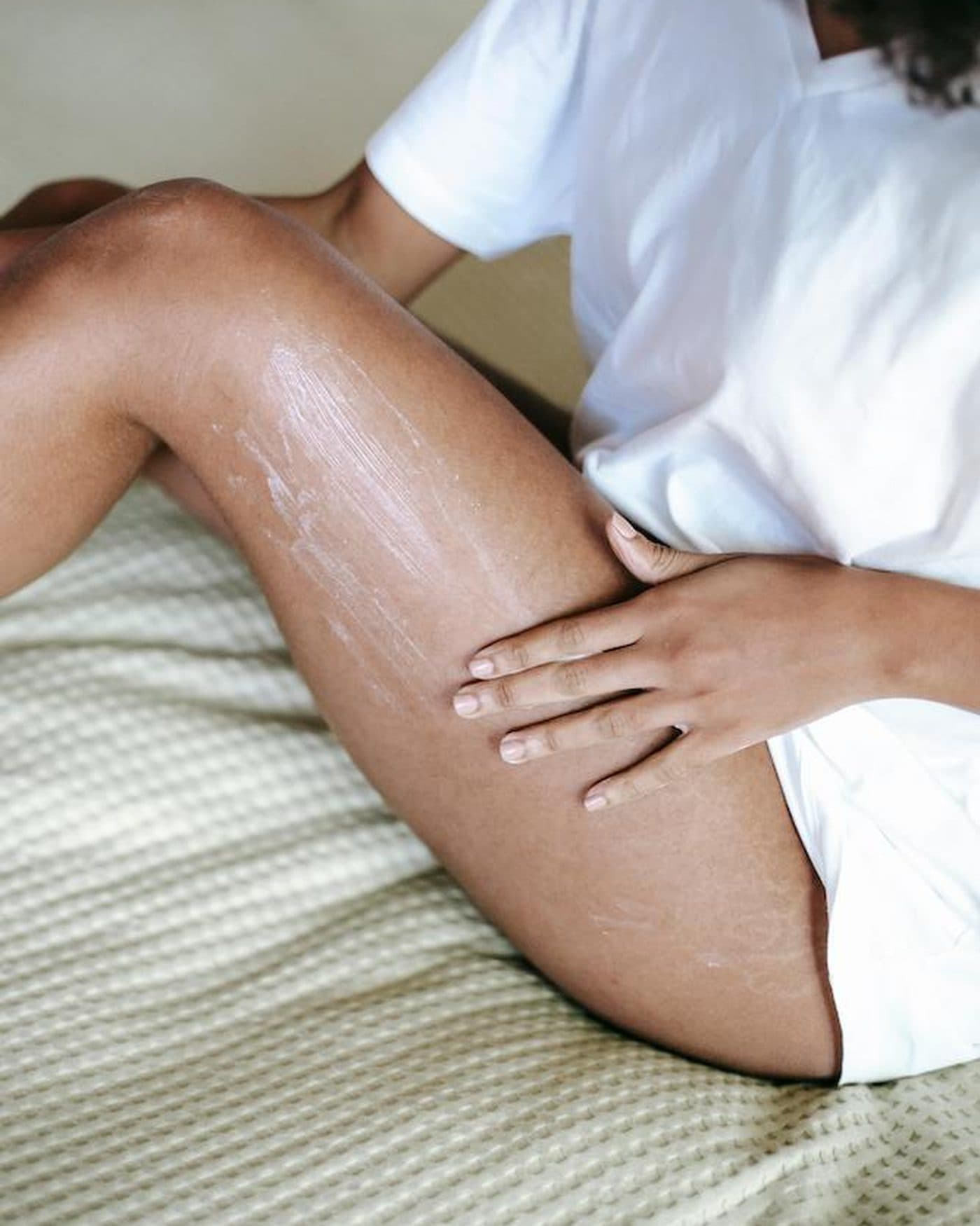 Moisturizer being smoothed over a thigh after treatment