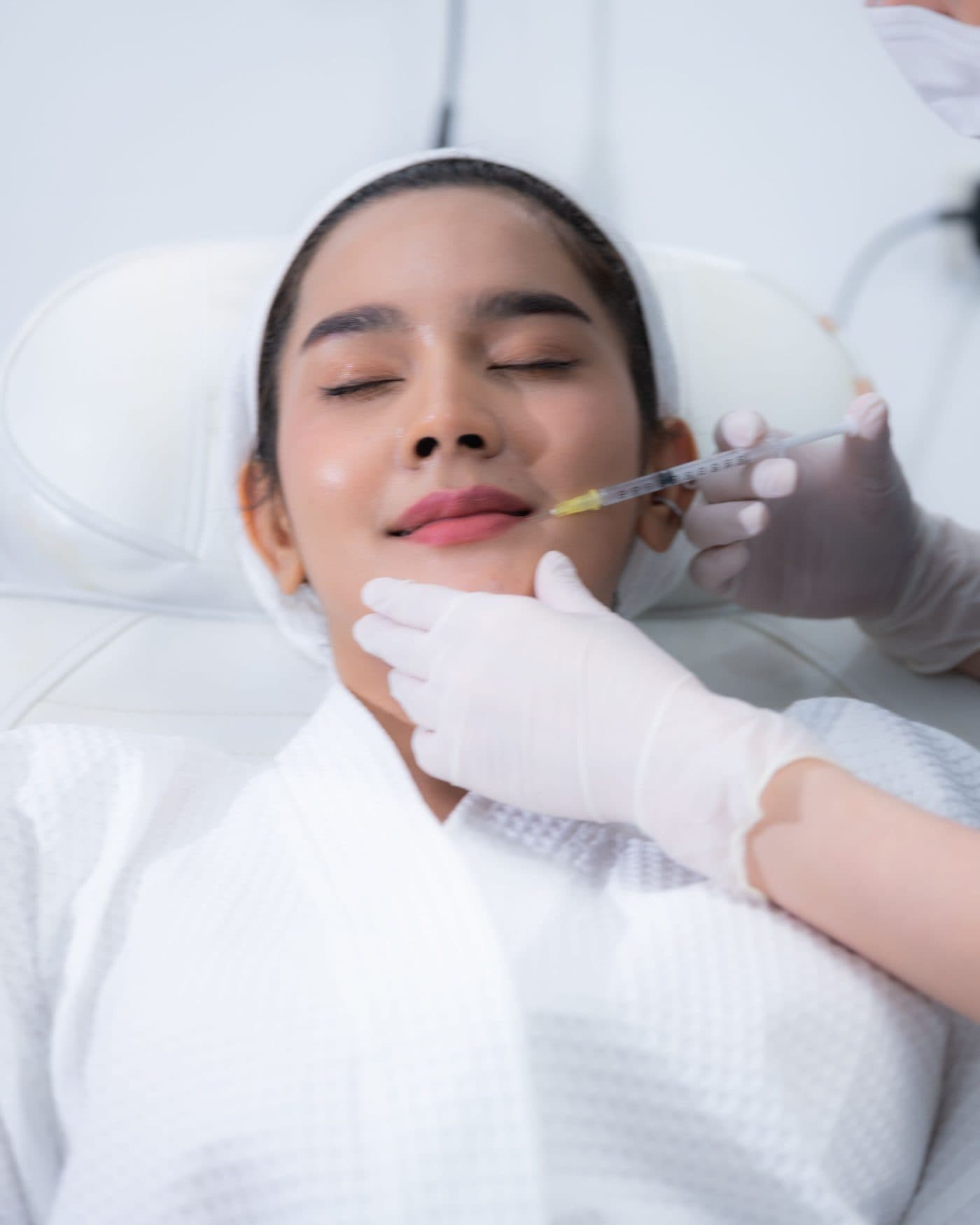 An injector treating a reclined patient’s face