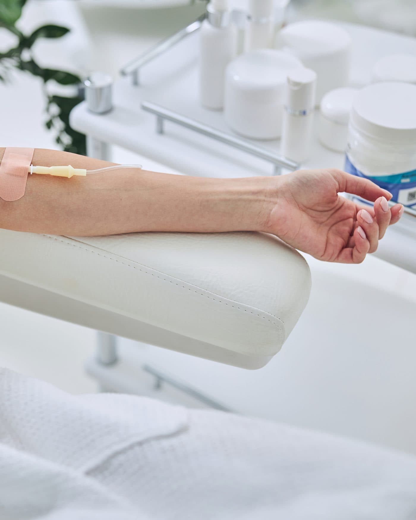 Close-up of an IV line taped to a patient’s forearm