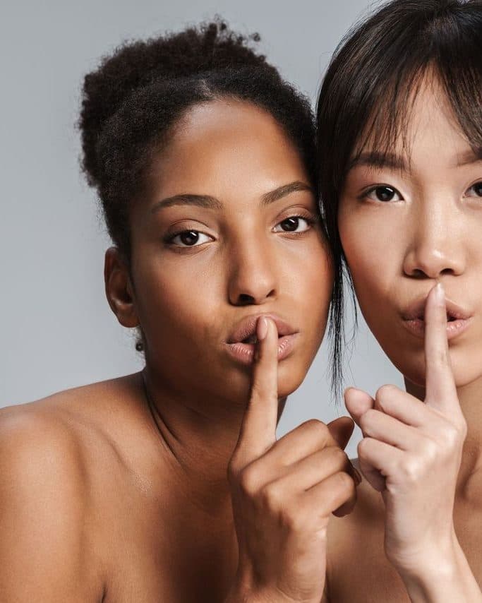 Woman with a finger held to her lips